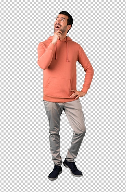 PSD man in a pink sweatshirt standing and thinking an idea while looking up