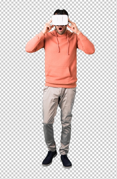 Man in a pink sweatshirt using vr glasses. virtual reality experience