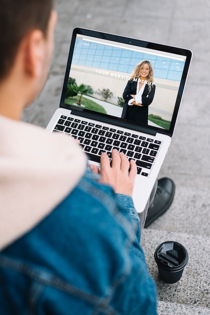 PSD man presenting laptop mockup