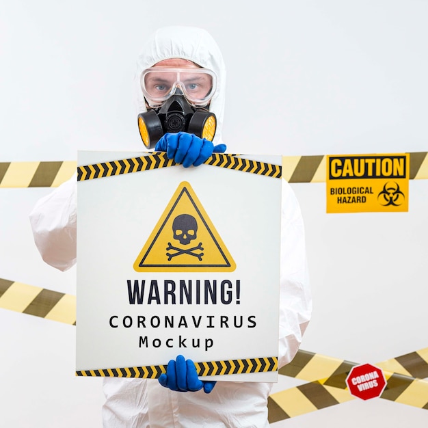 PSD man in protection suit holding a warning coronavirus mock-up