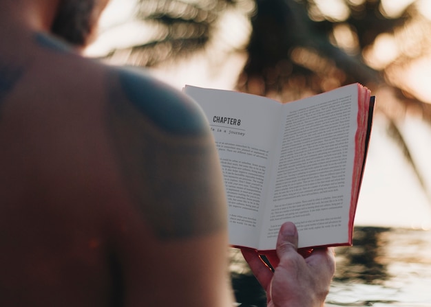 PSD man reading a book in the swimming pool