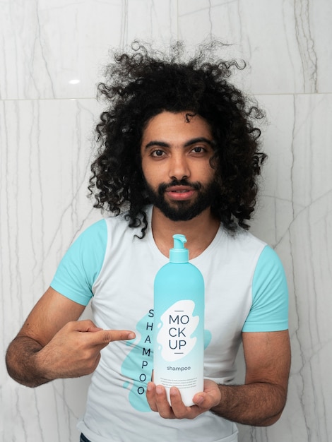 Man showing shampoo bottle mockup design