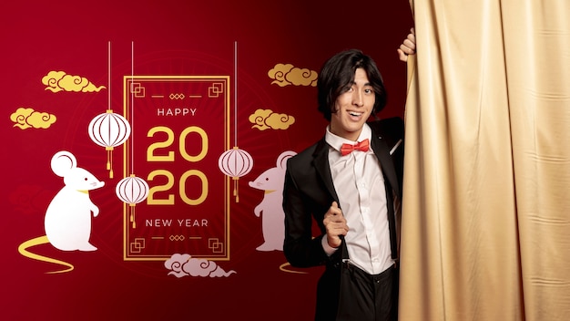 Man standing beside new year dated decoration