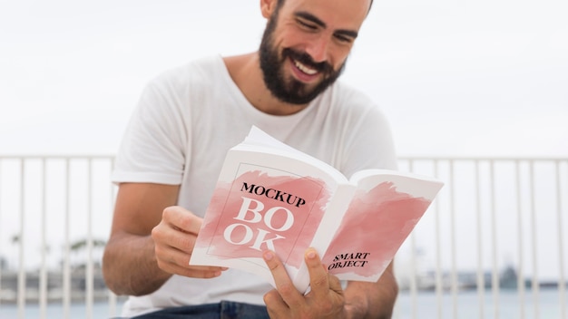 Man on street reading book