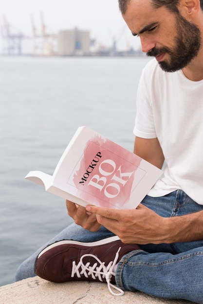 Man on street reading book