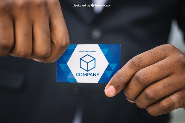 PSD man in suit holding business card mockup