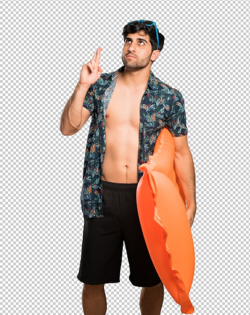 PSD man in trunks with fingers crossing and wishing the best