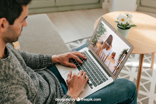 PSD man using laptop in living room