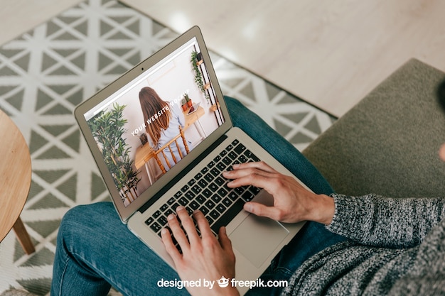 Man using laptop on sofa