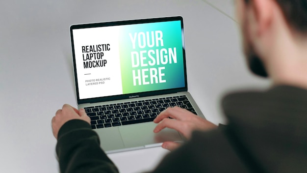 Man using laptop on table mockup
