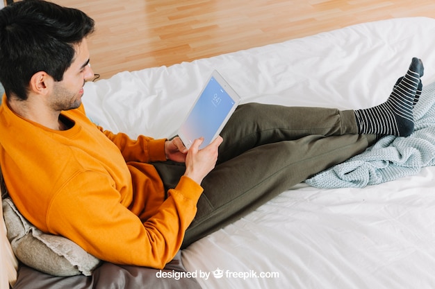 PSD man using tablet at home