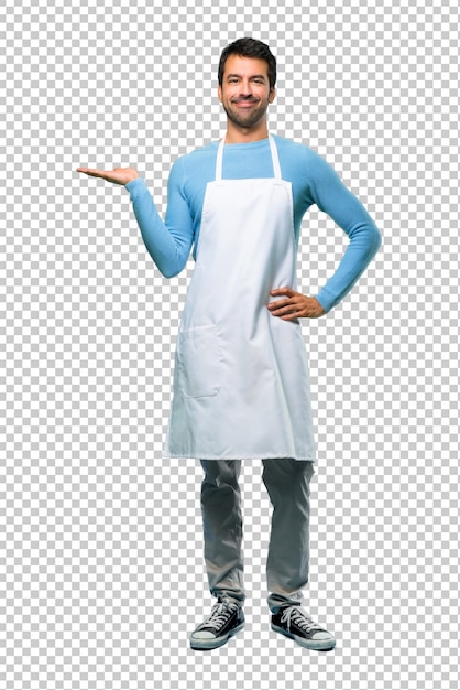 Man wearing an apron holding copyspace imaginary on the palm to insert an ad