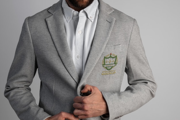 PSD man wearing stylish gray blazer with embroidery emblem