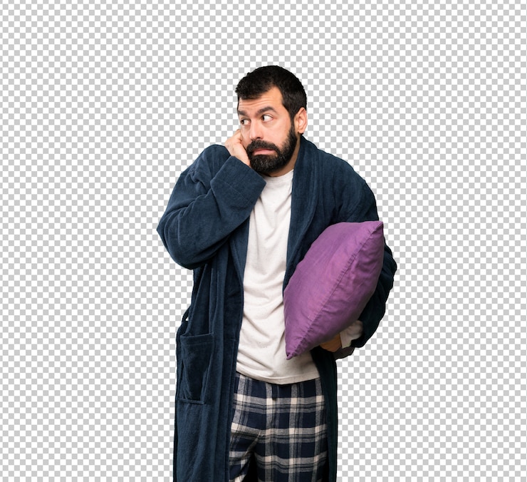 PSD man with beard in pajamas frustrated and covering ears