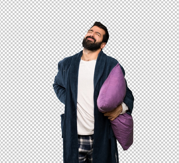 Man with beard in pajamas suffering from backache for having made an effort