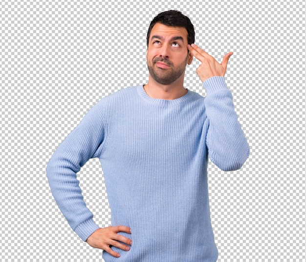 Man with blue sweater with problems and with unhappy expression making suicide gesture