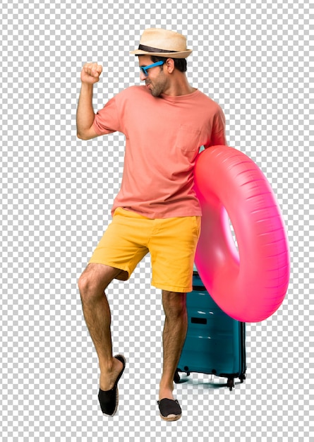 Man with hat and sunglasses on his summer vacation enjoy dancing while listening to music at a party