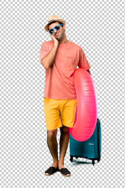 Man with hat and sunglasses on his summer vacation making sleep gesture. adorable and sweet expression