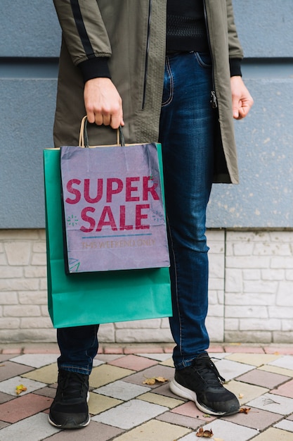 Man with shopping bags in city