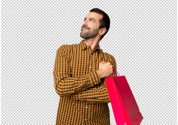 PSD man with shopping bags looking up while smiling