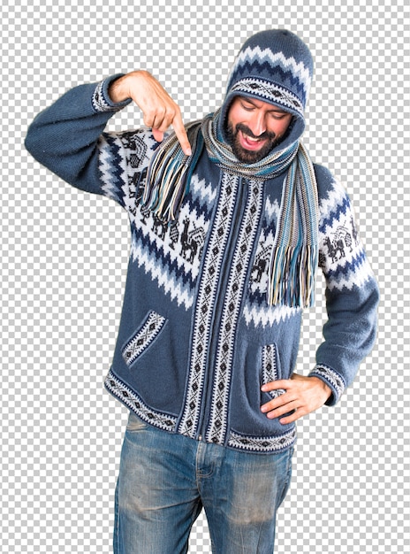 Man with winter clothes pointing down