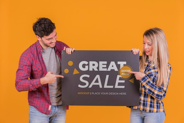 Man and woman holding a sign concept mock-up