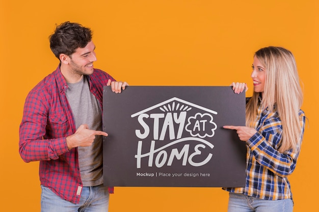 PSD man and woman holding a sign concept mock-up