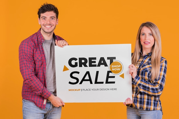 PSD man and woman holding a sign concept mock-up