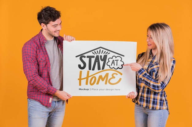 Man and woman holding a sign concept mock-up