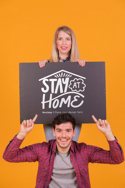 PSD man and woman holding a sign concept mock-up