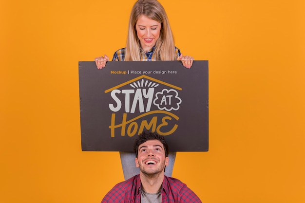 PSD man and woman holding a sign concept mock-up