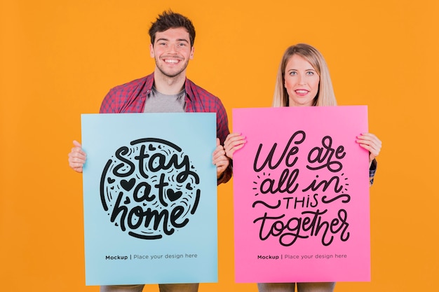 PSD man and woman holding a sign concept mock-up