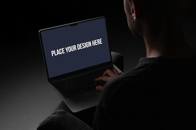 Man Working on Laptop in Dark Setting