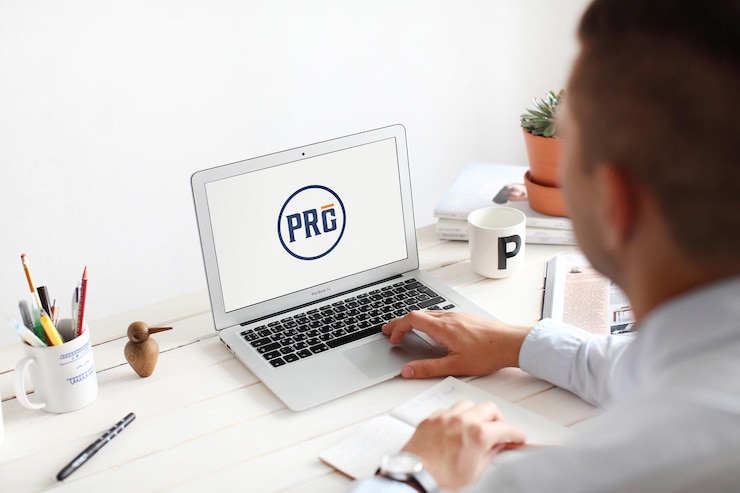 PSD man working on laptop at office desk mockup psd