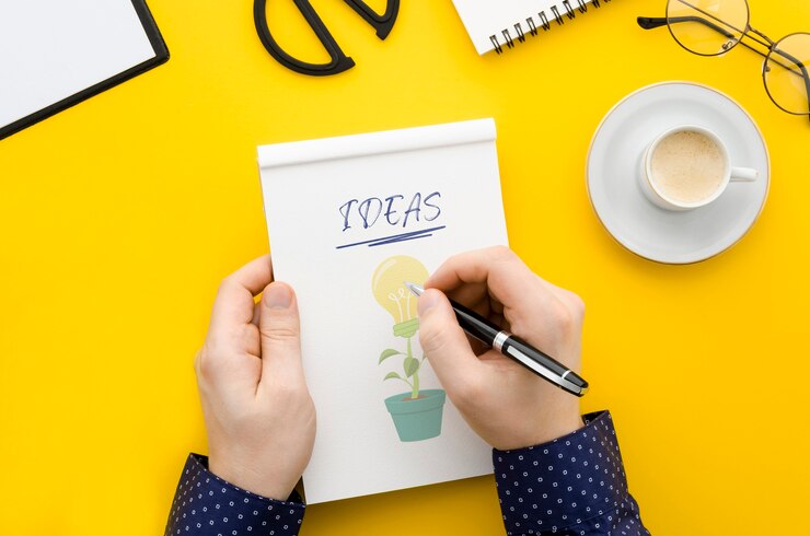 PSD man writing on notebook mock-up at desk