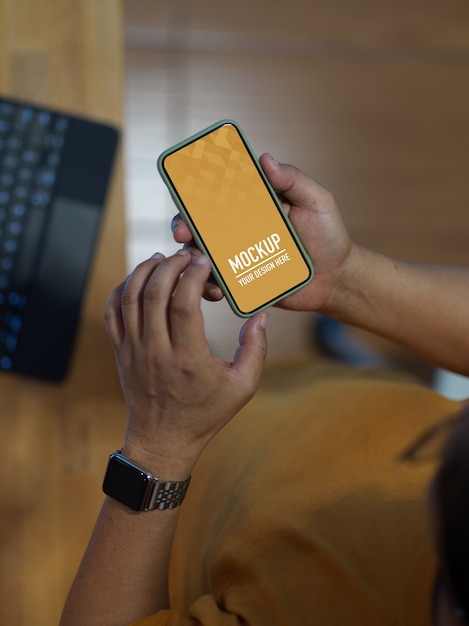 PSD mannenhand mockup smartphone gebruikt zittend in de kantoorruimte