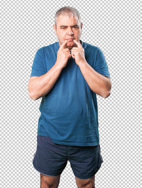 Mature man sad pointing his mouth