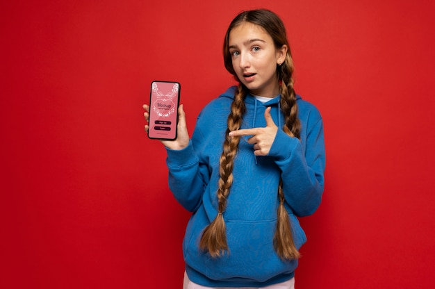 Medium shot girl holding phone