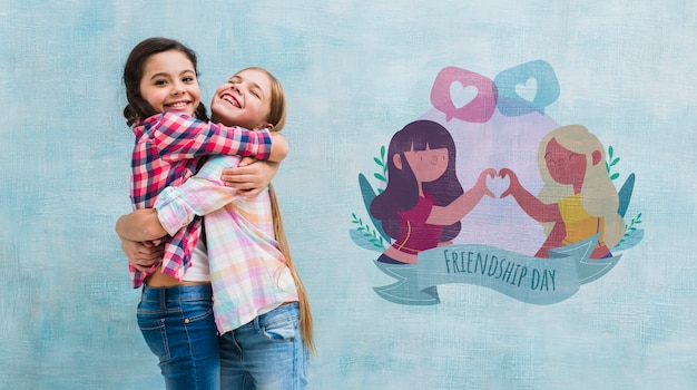 PSD medium shot little girls hugging with wall mock-up