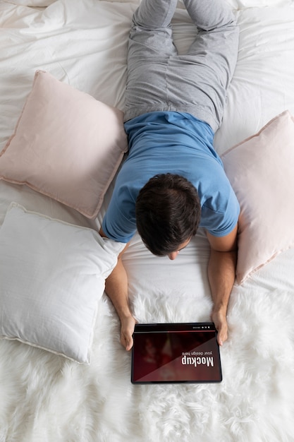 medium shot man watching movie on tablet