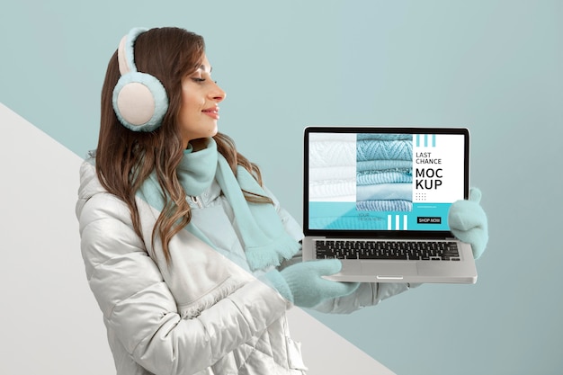 medium shot model holding laptop