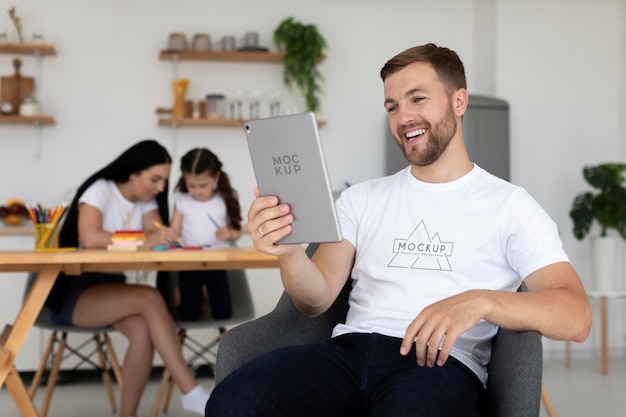 PSD medium shot smiley man holding tablet