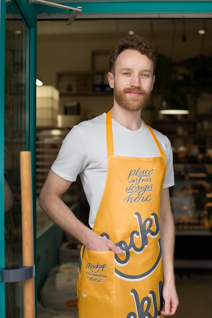 PSD medium shot smiley man wearing yellow apron