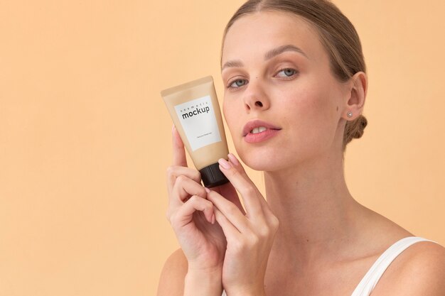 PSD medium shot woman holding cream