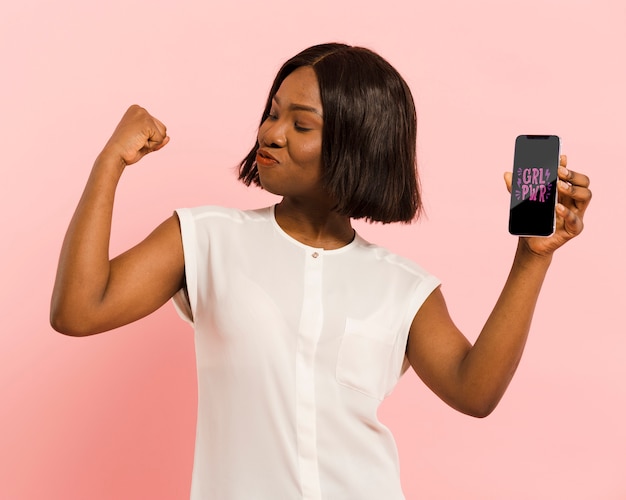 PSD medium shot woman holding a smartphone