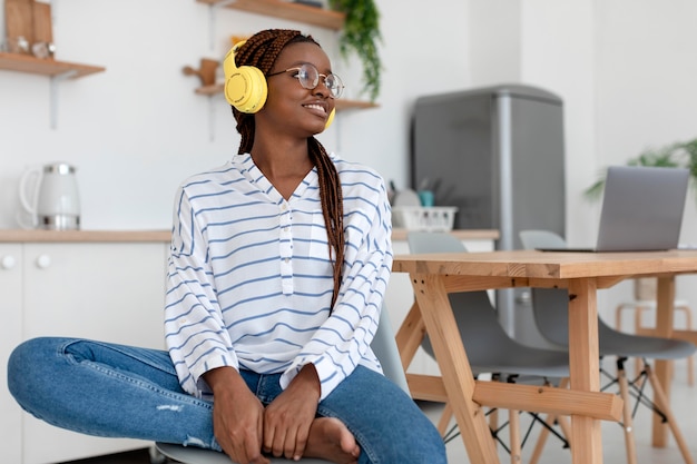 Medium shot woman wearing headphones