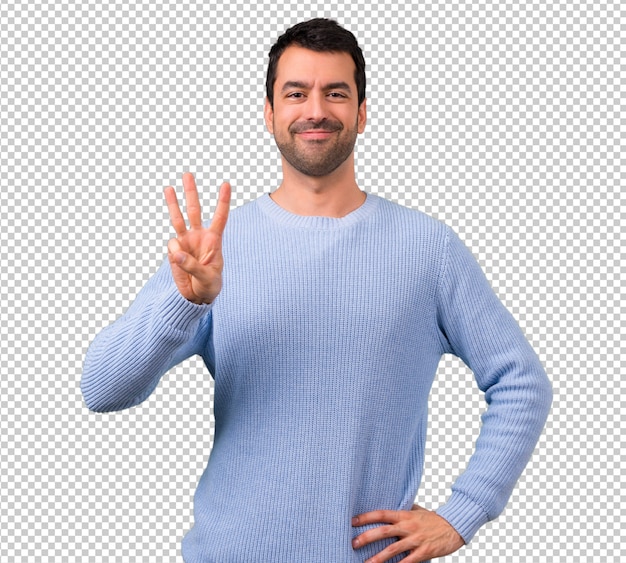 Mens met blauwe sweater die drie met vingers telt