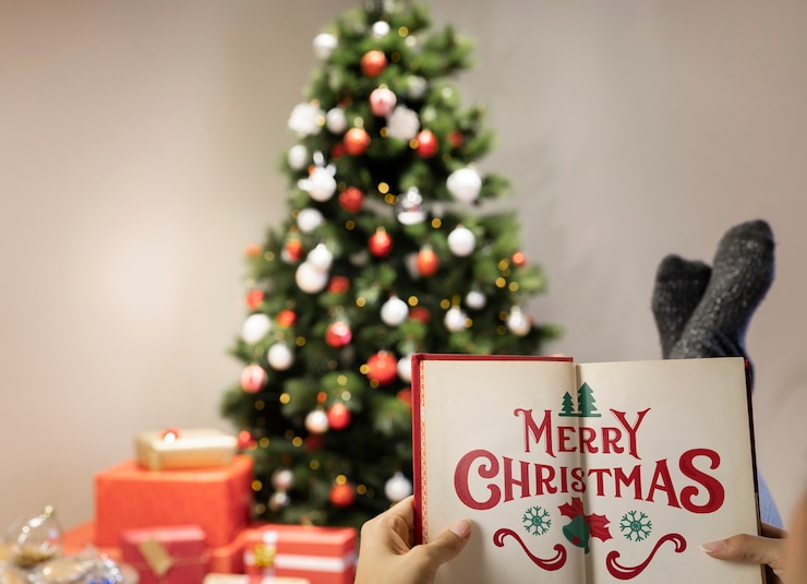 PSD merry christmas book with blurred christmas tree