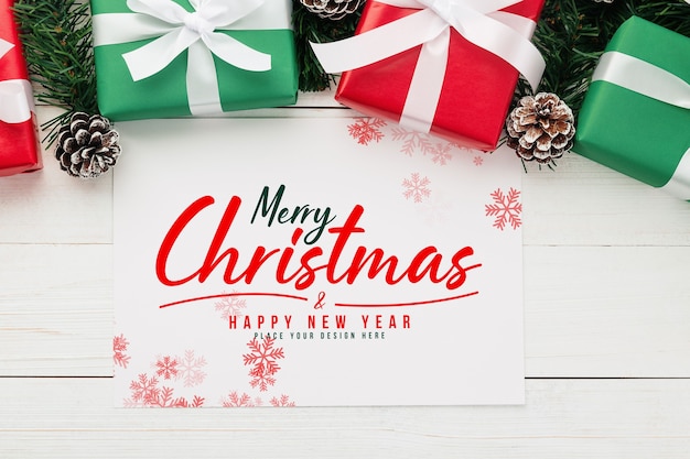 PSD merry christmas greeting card mockup with christmas gifts decorations