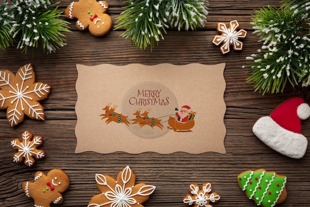 PSD merry christmas mock-up and candies and christmas pine leaves